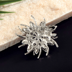 Vue arrière de la broche fleur argentée avec pierres bleues et fermoir épingle