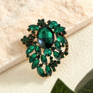 Elegant emerald green crystal leaf brooch with sparkling rhinestones in gold setting