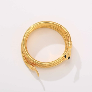 Eleganter goldener Schlangenarmreif mit flexiblem Tubogas-Design und schwarzen Edelsteinaugen