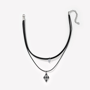 Double-layer necklace featuring black cords with a checkered diamond and round gem pendant