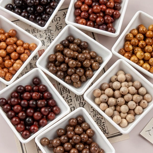 Close-up of assorted 10mm natural wood beads sorted in trays for DIY jewelry making