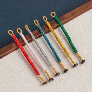 Close-up of handmade Vajra knot woven cords in six vibrant colors with wooden buckles