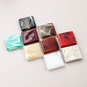 Detailed view of square resin beads with marble texture for DIY jewelry and swimsuits