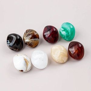 Detailed view of colorful irregular resin beads with artistic marble pattern for DIY jewelry