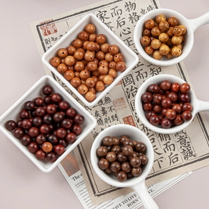 Various 10mm natural wooden beads in ceramic dishes for DIY jewelry and bracelet making