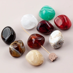 Detailed view of irregular colorful resin beads with marble texture for DIY jewelry making