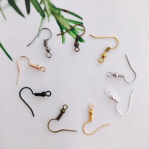 Flat lay of diverse alloy earring hooks in gold silver and bronze for DIY jewelry