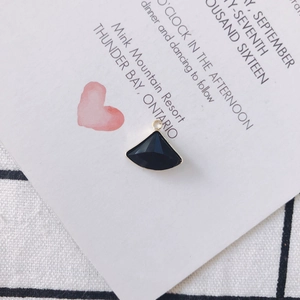 Detail view of fan-shaped black crystal charm with gold metal trim for DIY jewelry