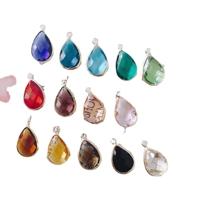 Set of 14 colorful faceted teardrop pendants with gold frames and internal lettering