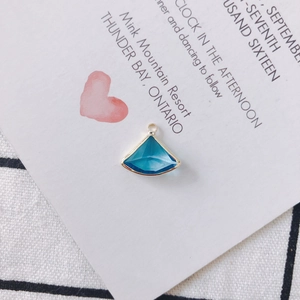 Detail of fan-shaped blue crystal pendant with gold alloy edging for DIY jewelry making