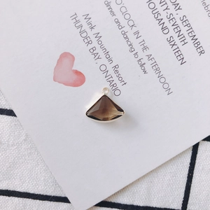 Macro view of smoky quartz fan-shaped crystal pendant with gold alloy edging for DIY jewelry