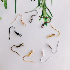 Assorted DIY jewelry ear hooks in various metallic finishes on clean white background