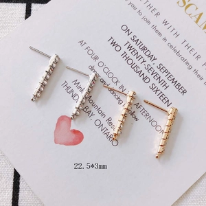 Detail of 22.5mm linear bar earrings with paved rhinestones on an elegant card