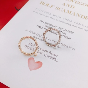 Close-up of gold and silver geometric circular earring components with micro-pave stones
