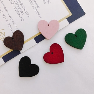 Macro shot of colorful heart-shaped wooden jewelry charms for DIY earring and pendant making