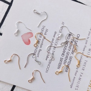 Detail view of gold and silver S925 sterling silver earring hooks with spring and loop