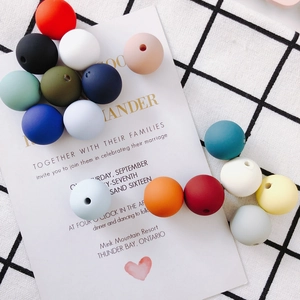 Close-up of colorful matte silicone beads with holes for DIY jewelry making and crafts