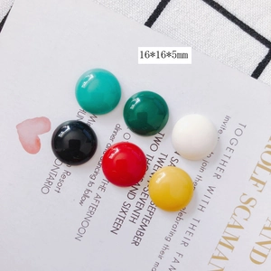 Detail of semi-round 16mm resin beads in mixed colors on decorative card background