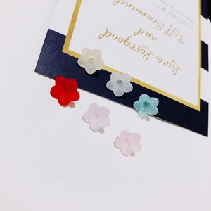 Close-up of candy-colored resin flower beads in five petals for DIY jewelry making