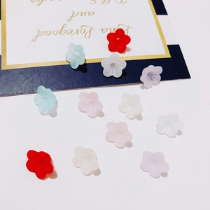 Detail of candy-colored resin flower charms for DIY jewelry making and handmade crafts
