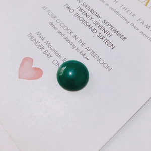Macro shot of a green cabochon resin pendant for DIY jewelry making accessories