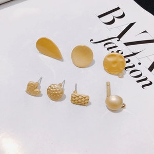 Matte gold alloy geometric earring set with heart and round shapes on fashion magazine