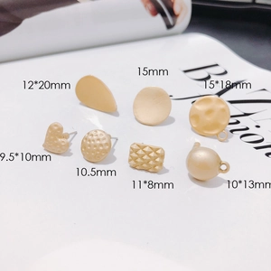 Selection of golden alloy jewelry findings in heart and geometric shapes with size markings