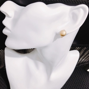 Detail view of a matte gold round earring stud with loop for DIY jewelry making