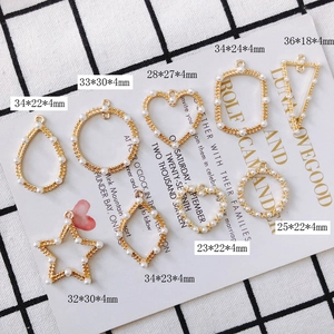 Detailed close-up of geometric gold-plated DIY jewelry charms with white pearls
