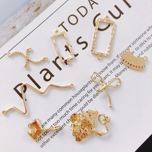 Gedetailleerd macrobeeld van diverse gouden DIY-sieradenhangers en geometrische vormen