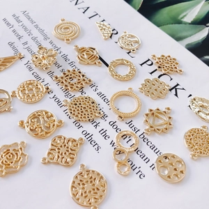 Flat lay of assorted gold-plated alloy pendants for DIY jewelry making accessories