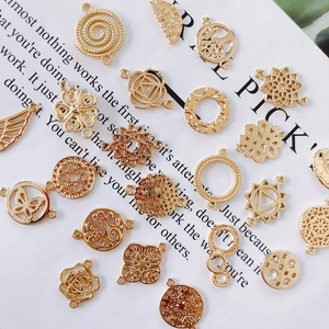 Detailed flat lay of golden alloy connectors for DIY jewelry making with mandala motifs