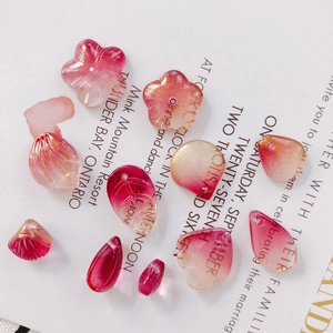 Macro shot of translucent pink gradient flower and leaf beads with gold foil for DIY jewelry