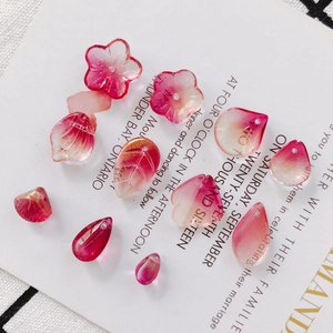 Macro detail of pink glass flower and leaf beads for DIY handmade jewelry components