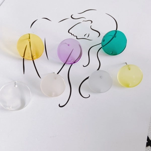 Colorful acrylic round stud earrings set with silver needles on artistic line art card