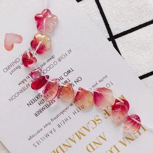 Detail of pink gradient leaf and flower beads with gold glitter for DIY jewelry making