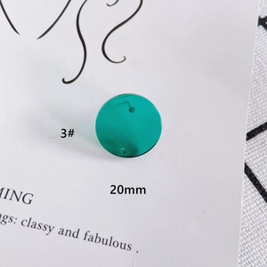Macro detail of a 20mm round translucent green resin earring component for DIY jewelry