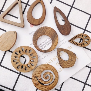 Various geometric wooden earring charms featuring laser-cut floral and leaf patterns
