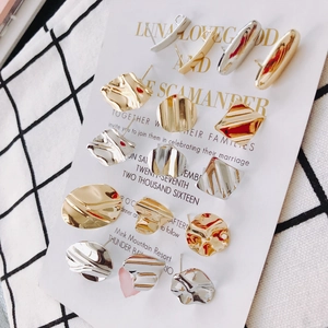Detail view of s925 silver needle earrings with gold and silver ripple textures on card