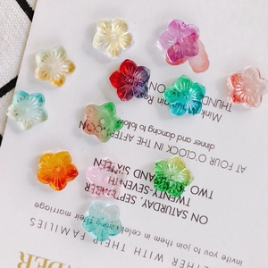 Macro shot of colorful petal-shaped glass beads for DIY jewelry on artistic background