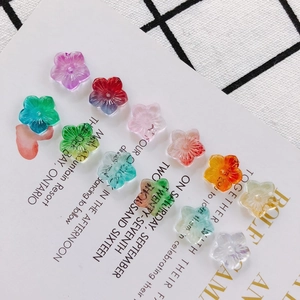 Macro shot of colorful five-petal glass flower beads for DIY jewelry making and earring design