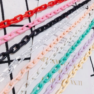 Colorful acrylic plastic chains in various pastel tones on a decorative background