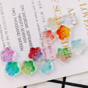 Detailed view of colorful flower-shaped glass beads for DIY jewelry making and crafts