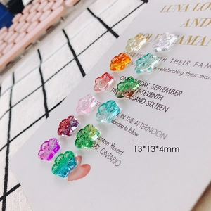 Macro shot of 13x13mm five-petal crystal glass flower beads in various transparent colors