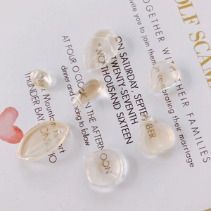 Champagne petal glass beads for DIY jewelry making on vintage white card background