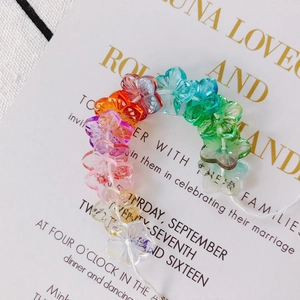 Macro shot of colorful gradient crystal flower beads for DIY handmade jewelry crafting