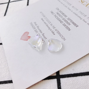 Iridescent heart-shaped crystal beads for DIY jewelry making on a minimalist background