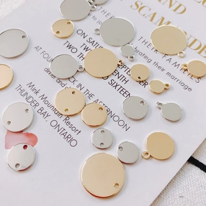 Macro shot of assorted gold and silver circular metal charms with holes for DIY jewelry