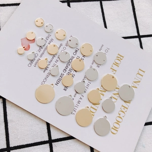 Detailed macro view of gold and silver plated round jewelry charms in various sizes