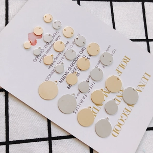 Macro shot of gold and silver plated round copper charms for DIY jewelry making and earrings